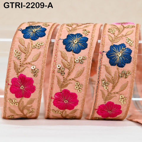 three decorative fabric pieces with floral patterns in shades of blue and pink. The pieces appear to be made of a soft, beige-colored material and are embellished with gold and pink embroidery.