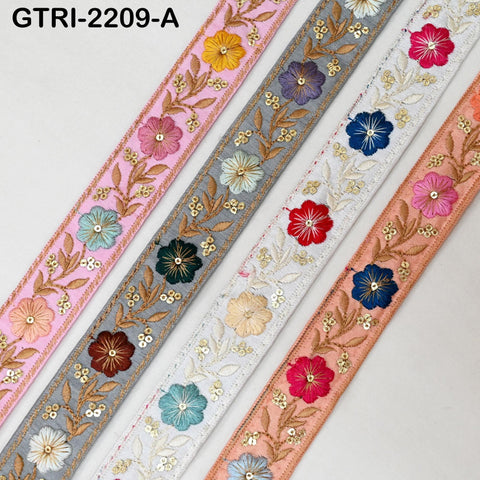 a collection of colorful, embroidered fabric strips arranged in a row.
