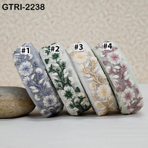 four decorative headbands with floral patterns, each with a different color and design.
