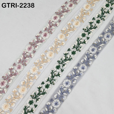 a collection of decorative fabric pieces with floral embroidery in various colors and patterns, including pink, white, green, and blue flowers.