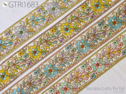 a close-up view of a decorative floral embroidery ribbon with a repeating pattern of colorful flowers and leaves.