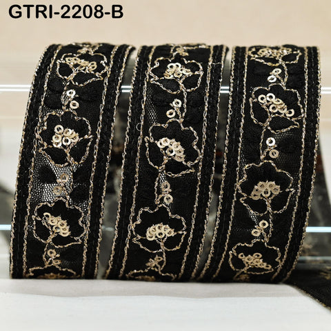three black and gold floral embroidered ribbons arranged in a row.