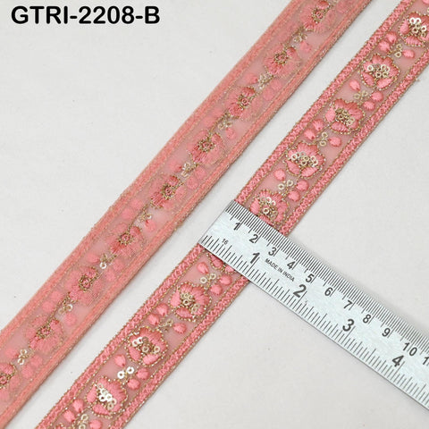 a pink decorative fabric with a floral pattern, and a ruler is placed next to it, indicating the size of the fabric.