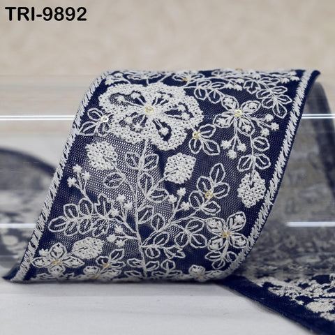 a close-up view of a decorative fabric with a floral pattern in shades of blue and white.