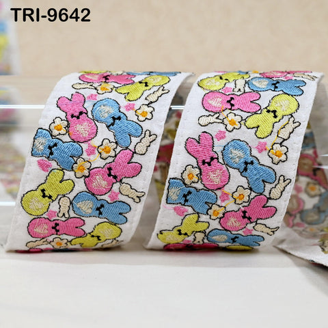 a close-up view of a colorful, embroidered ribbon with a playful bunny pattern.
