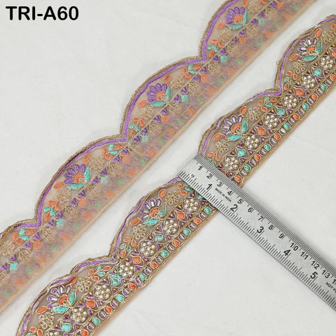 a decorative fabric with a floral pattern, featuring a ruler placed on it to measure its length.