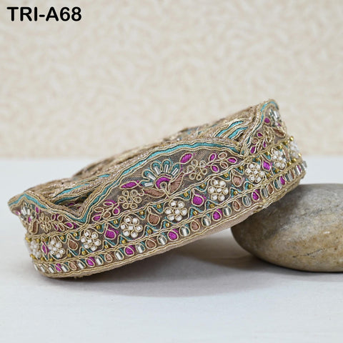 a decorative border with intricate embroidery and embellishments, including a variety of colors and patterns.