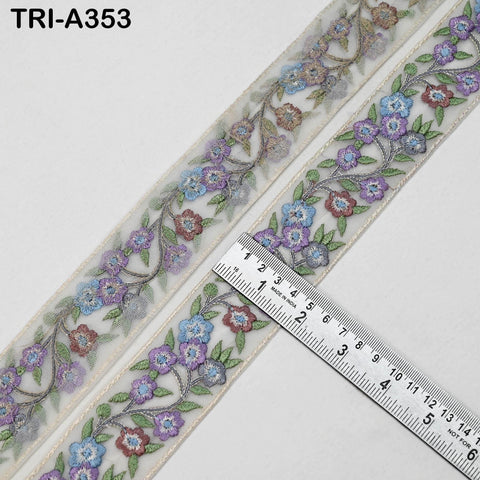 a decorative fabric with a floral pattern, featuring a ruler placed on top of it to measure the length.