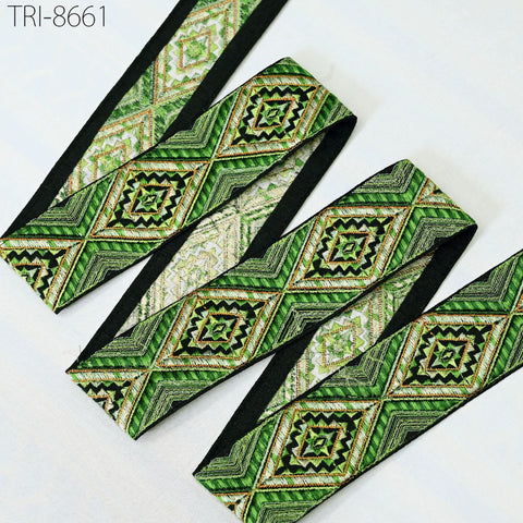 a collection of green and black patterned fabric pieces, including a black and green fabric strip and a green and black fabric strip.