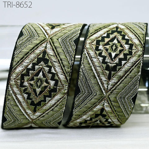 two decorative fabric pieces with intricate geometric patterns in shades of green and black.