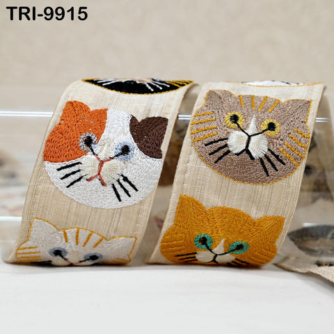 two beige fabric items with cat embroidered designs on them.