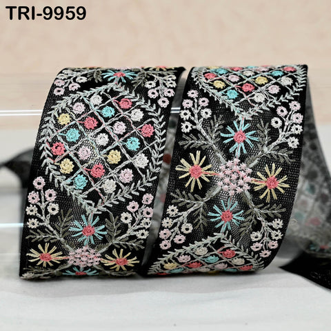 two decorative fabric pieces with intricate floral embroidery in black, pink, and yellow colors.